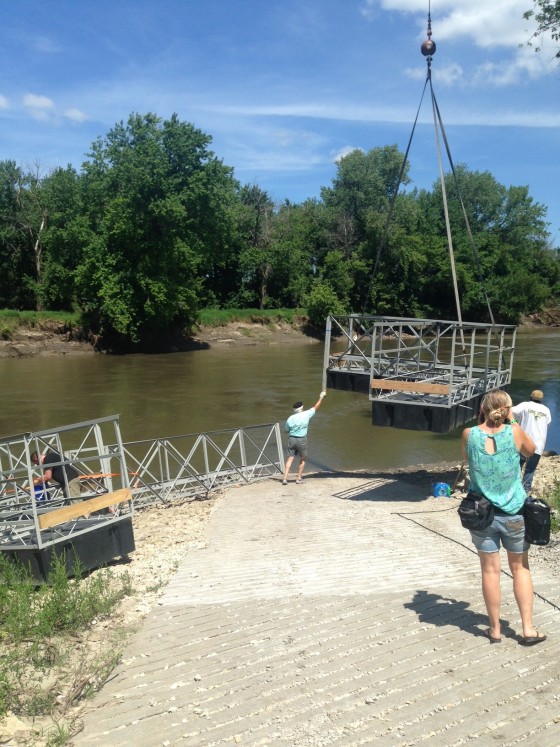 The installation of the art in the river was made possible by the generous volunteer work of Michael LaValle (pictured center, during installation), president of Port of Des Moines, LLC, and Tim Monson of Shuck-Britson. 